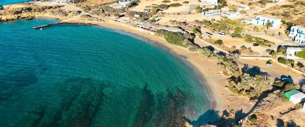 Aerial drone view of Foinikas Beach in Koufonisia island with calm blue waters and golden sand