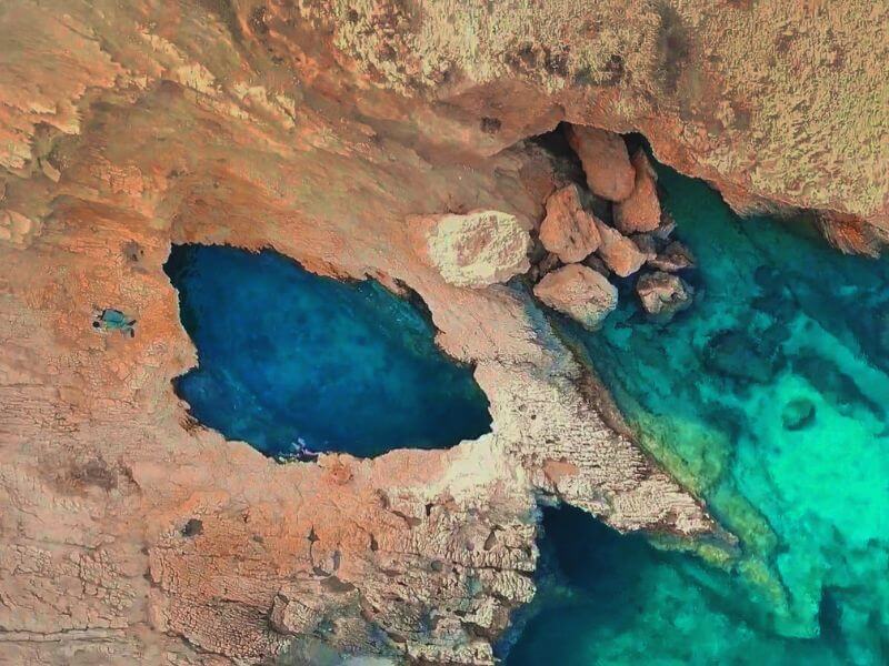 Pisina beach in Koufonisia with turquoise waters and rocky surroundings